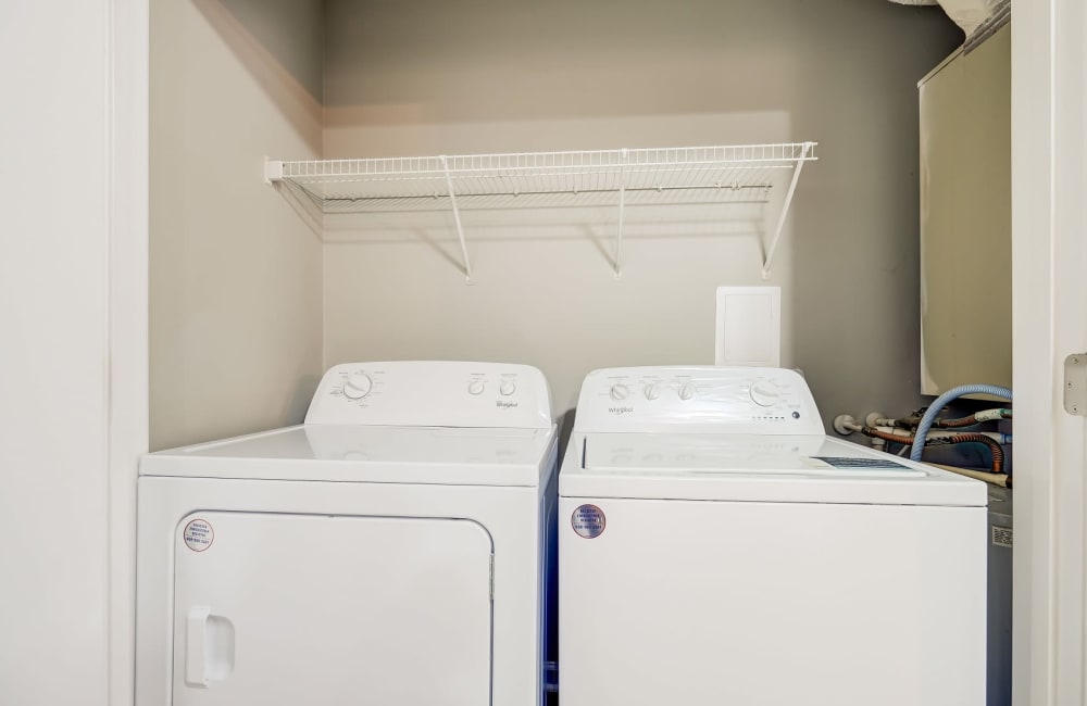 Washer and dryer combo area in apartments with utilities included located at Highland Ridge Apartment Homes in High Point, North Carolina
