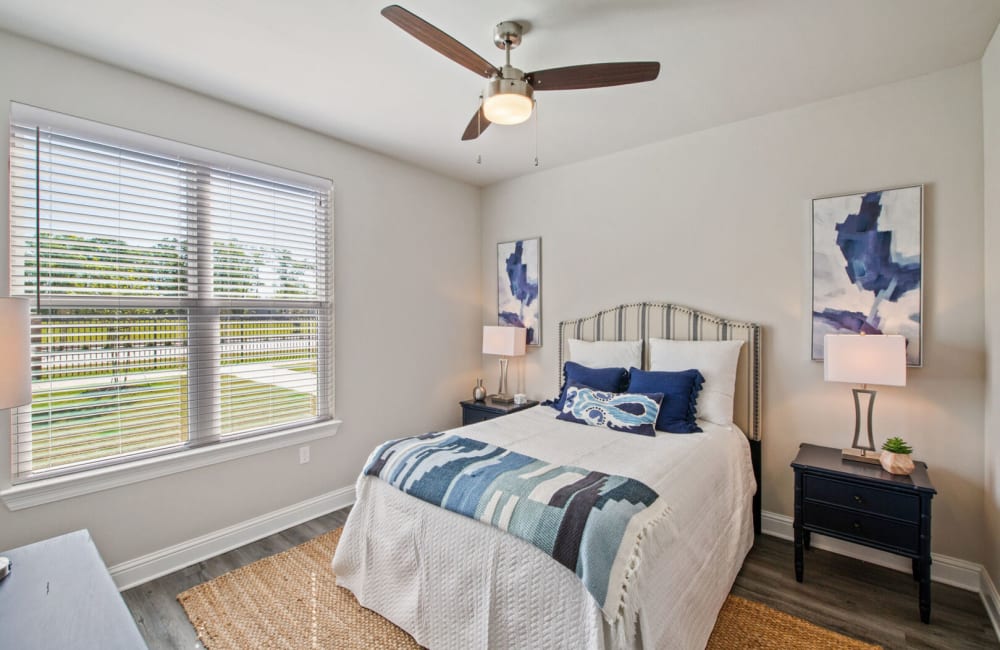 Bedroom with blue accents at The Waters at Hammond in Hammond, Louisiana