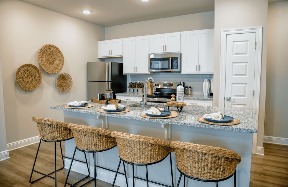 Model kitchen with dining area at The Waters at Ransley in Pensacola, Florida
