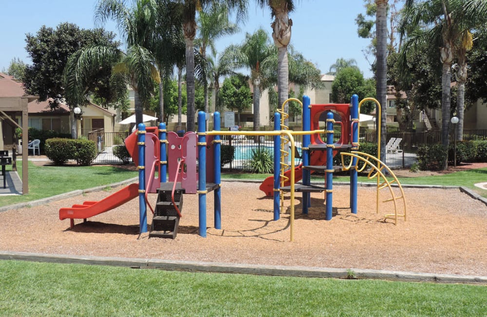 Outdoor playground at Peppertree Place Apartments in Riverside, California