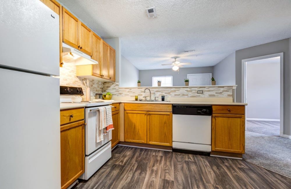 Beautiful modern kitchen with white appliances at Kannan Station Apartment Homes in Kannapolis, North Carolina