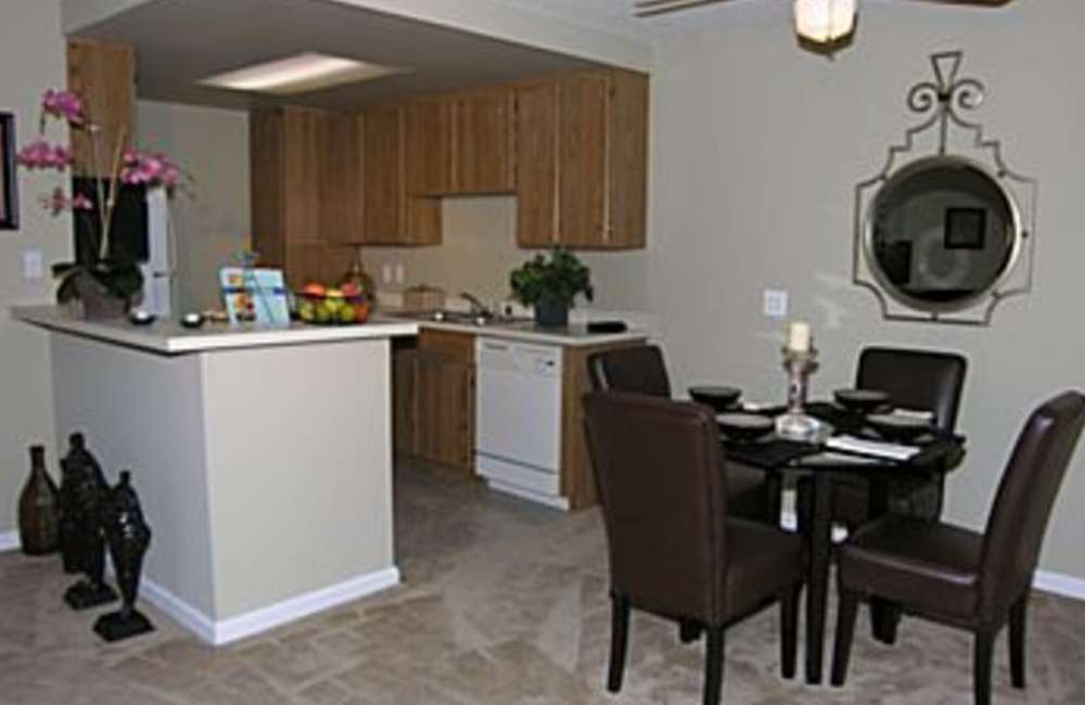 Dining table close to fully equipped kitchen and living room at Reidy Creek Apartments in Escondido, California
