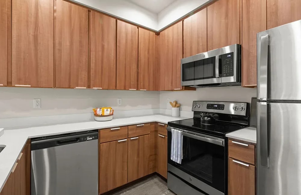 Model kitchen with stainless-steel appliances at Bella on Canyon in Puyallup, Washington