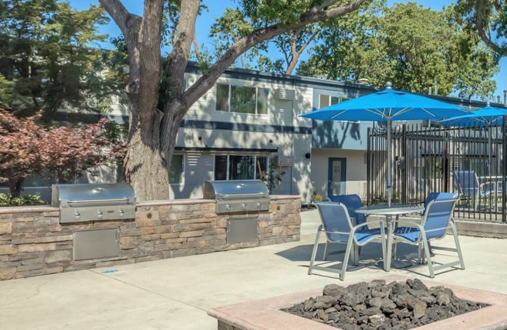 Outdoor grill station with picnic table at Academy Lane Apartment Homes in Davis, California