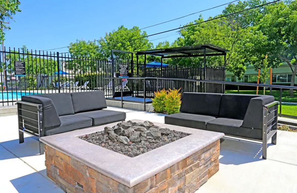 Outdoor lounge with fire pit at Academy Lane Apartment Homes in Davis, California
