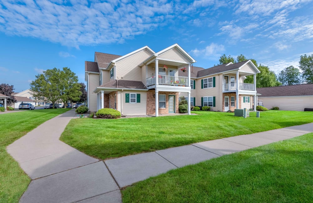 Exterior with private patio and lush lawn at Westview Commons Apartments in Rochester, New York