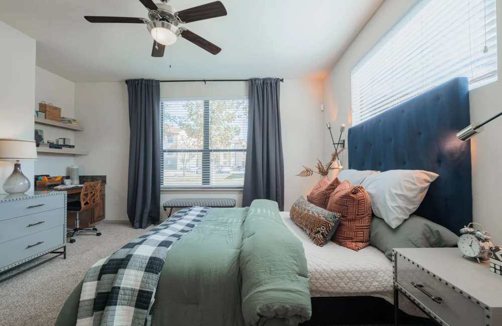 Bedroom with a ceiling fan at The Pines at Woodcreek in Humble, Texas