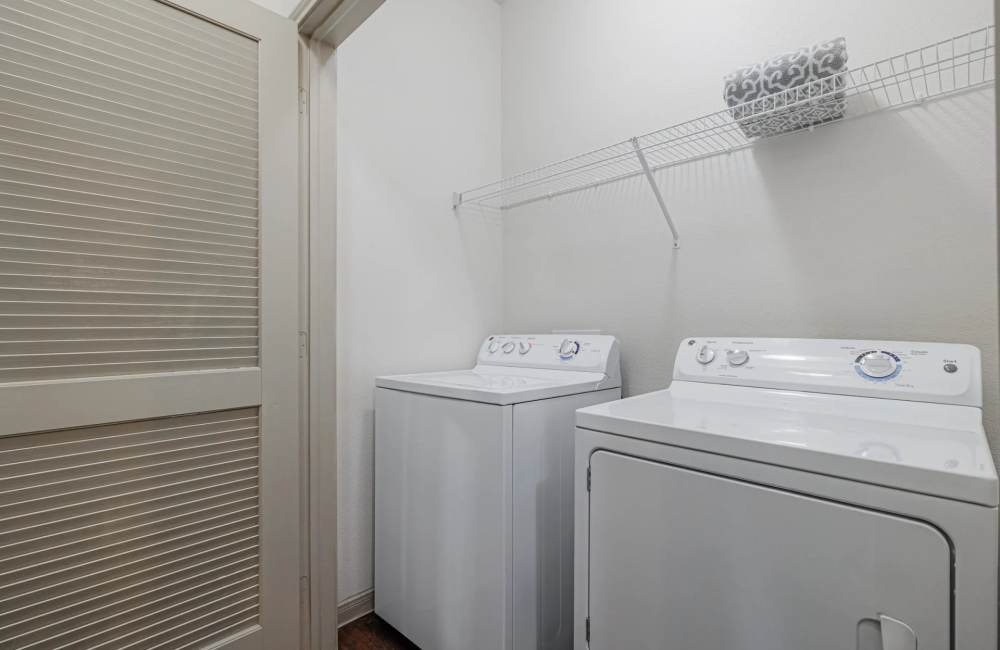 Washer and dryer in an apartment at The Pines at Woodcreek in Humble, Texas