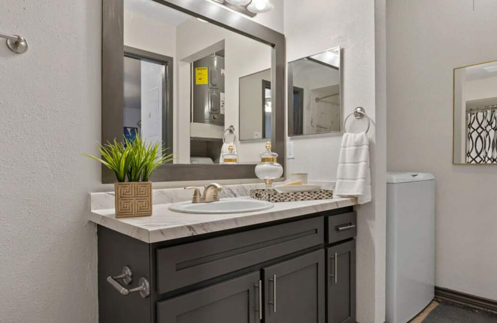Bathroom with a washer and a large mirror at Hill At Woodway in San Antonio, Texas