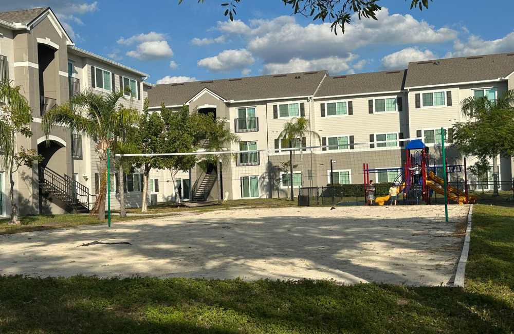 An on-site volleyball court and playground at Hawk's Landing in Fort Myers, Florida