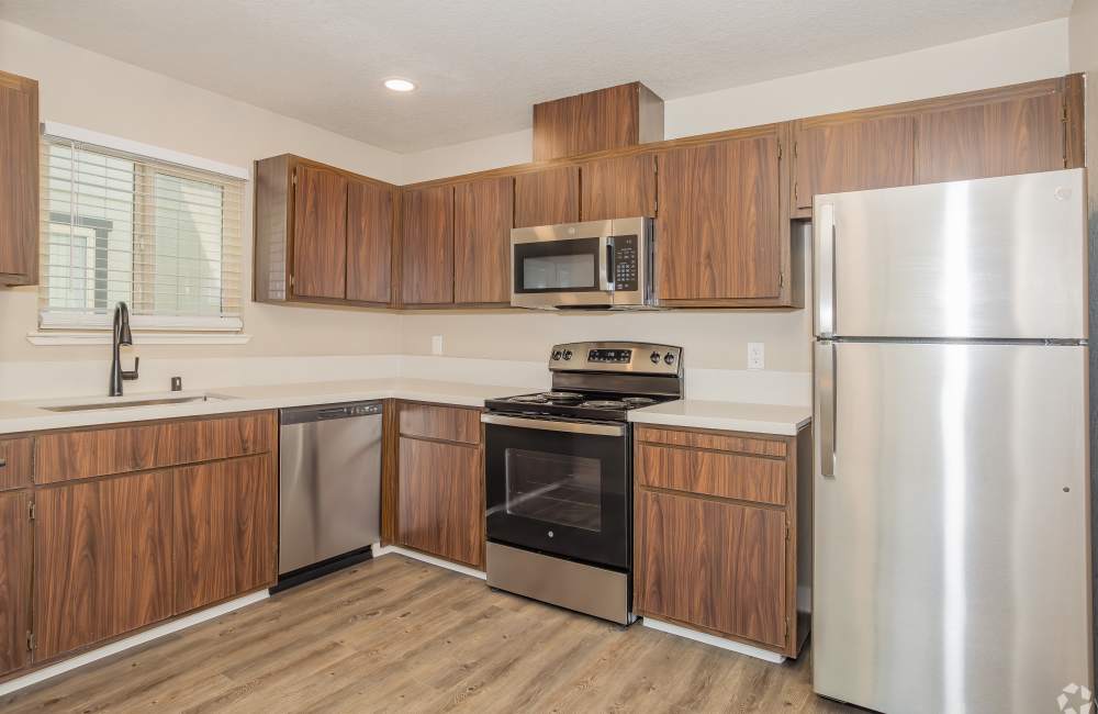 Kitchen with new cabinetry and stainless-steel appliances at El Macero Apartments in Davis, California