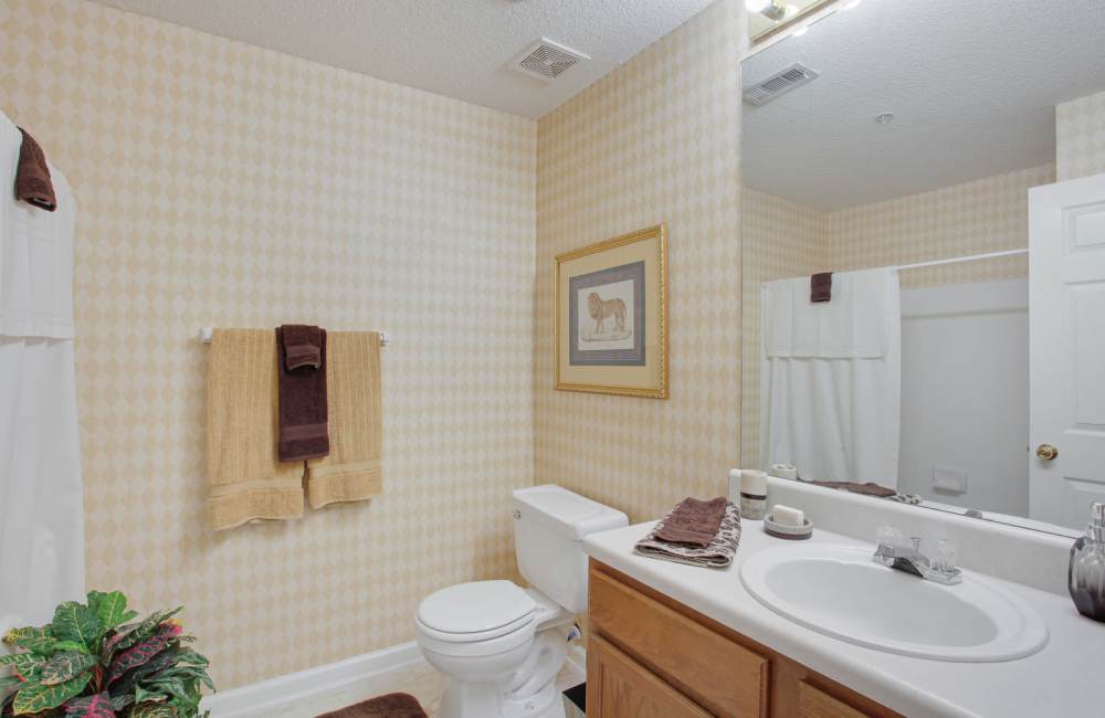 Bathroom with large mirror at Wellington Point in Atlanta, Georgia