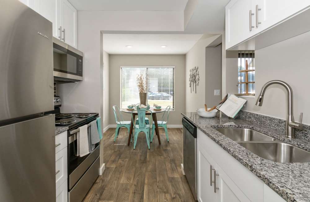 Kitchen with white cabinets and stainless appliances at Parkside at Castleton Square in Indianapolis, Indiana