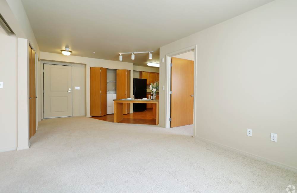 Spacious living room with plush carpeting at The Blakely in Shoreline, Washington