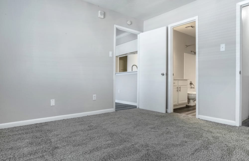 Bedroom with attached bathroom with a washer and a closet at Rayfords Edge Apartments in Spring, Texas Friday, November 15