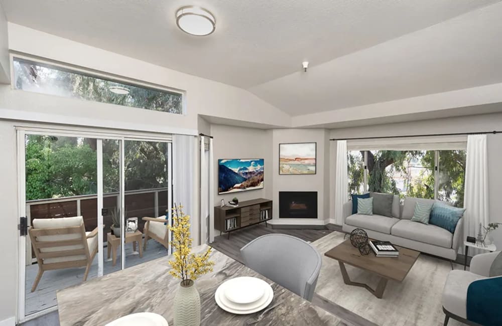 Living room with attached balcony at Gateway Apartments in San Leandro, California