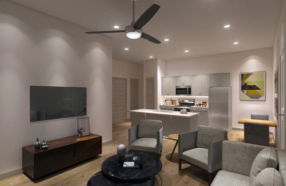 A modern living room with a white couch, green armchair, black coffee table at The Waters at Crestview in Crestview, Florida