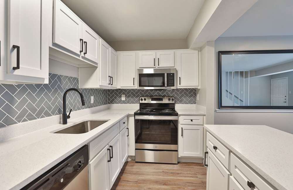 Spacious kitchen with hard-wood style flooring at Verlaine on the Parkway in Dallas, Texas, 