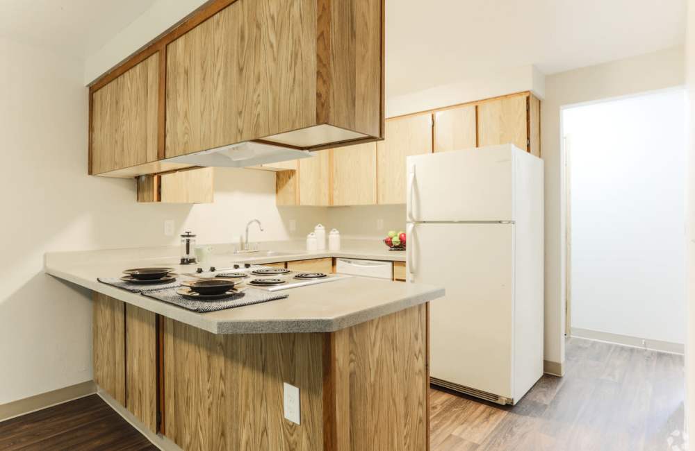 Kitchen with white refrigerator at Heron Hills Apartment Homes in Gresham, Oregon