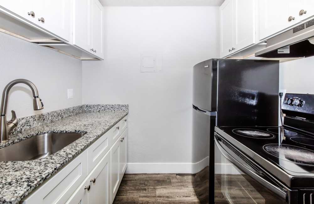 Kitchen with white  cabinets at Aero Place Apartments in Colorado Springs, Colorado