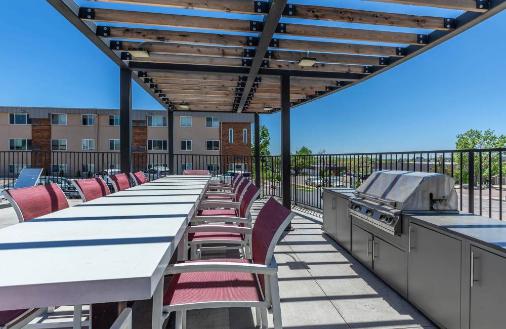 Grilling station with seating area at North 49 Apartments in Colorado Springs, Colorado