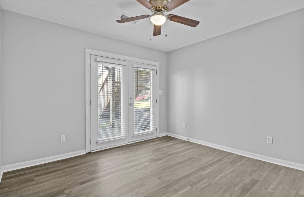 Comfortable king size bed with decorative windchimes at Mt. Tabor Apartments in Lexington, Kentucky