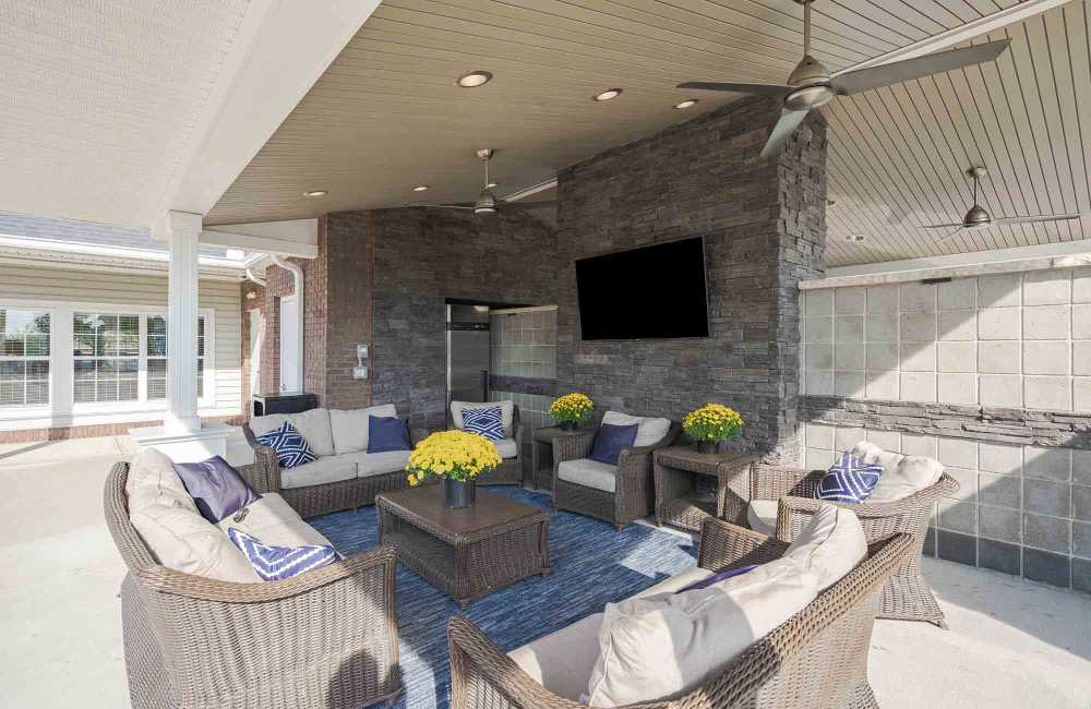 Outdoor lounge area with a TV at Charleston Pines Apartment Homes in Florence, Kentucky