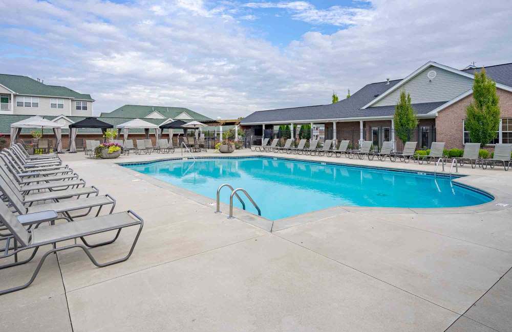 Lounge chairs by the pool at Aspen Pines Apartment Homes in Wilder, Kentucky