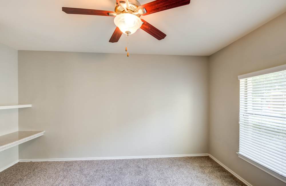 Bedroom with plush carpeting and large window at The Forum at Grand Prairie in Grand Prairie, Texas, 