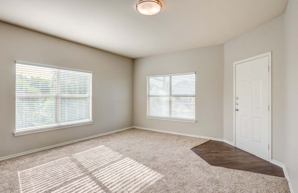 Bedroom with plush carpeting and large window at The Forum at Grand Prairie in Grand Prairie, Texas, 