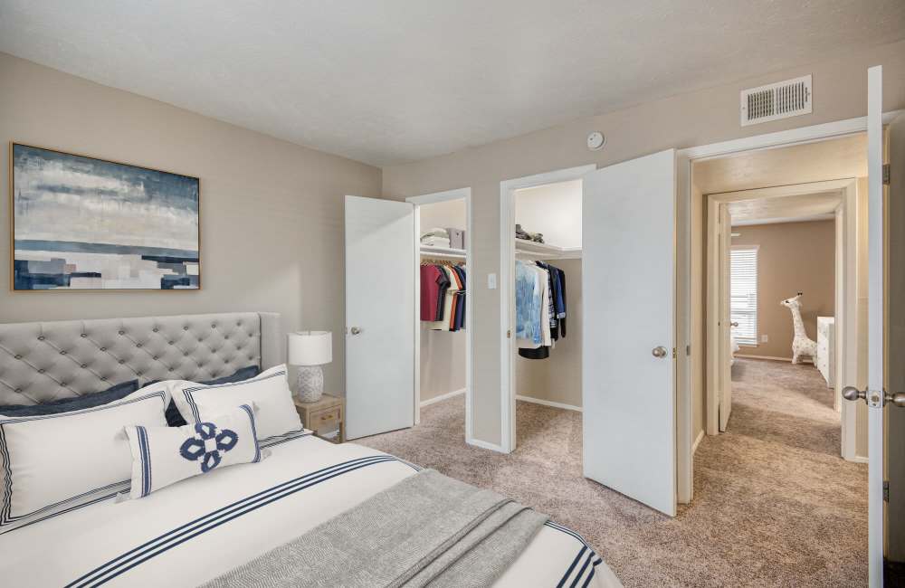Spacious bedroom with large comfortable bed and walk-in closets at Lakeridge Heights in Dallas, Texas, 