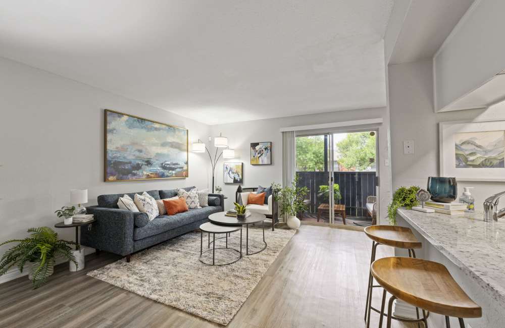 View of living room and balcony at Northside Heights in Conroe, Texas