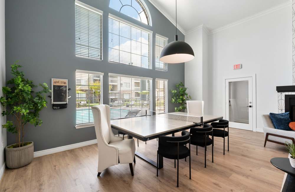 Modern design clubhouse with large lounge chairs at Park At Woodmoor Apartments in Shenandoah, Texas, 