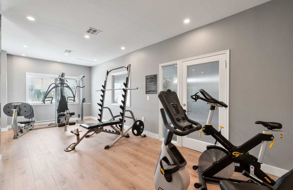 Fully-equipped fitness center at Park At Woodmoor Apartments in Shenandoah, Texas, 