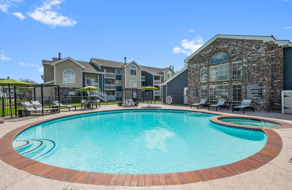 Sparkling water swimming pool at Park At Woodmoor Apartments in Shenandoah, Texas, 
