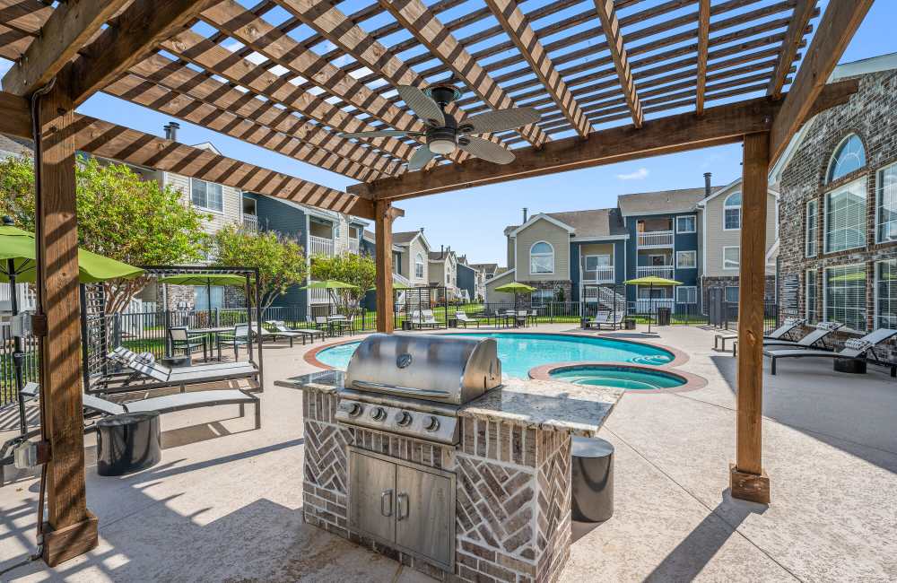 Outdoor community barbecue grills at Park At Woodmoor Apartments in Shenandoah, Texas, 