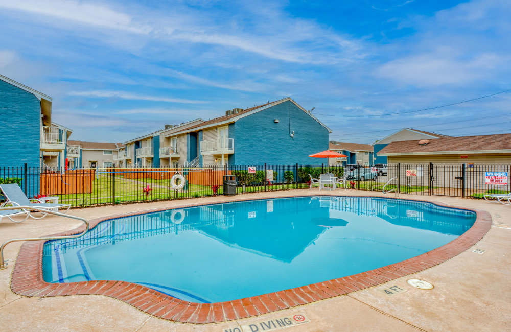 Large beautiful swimming pool with buildings in the background at South Shore Coastal Living in Corpus Christi,Texas