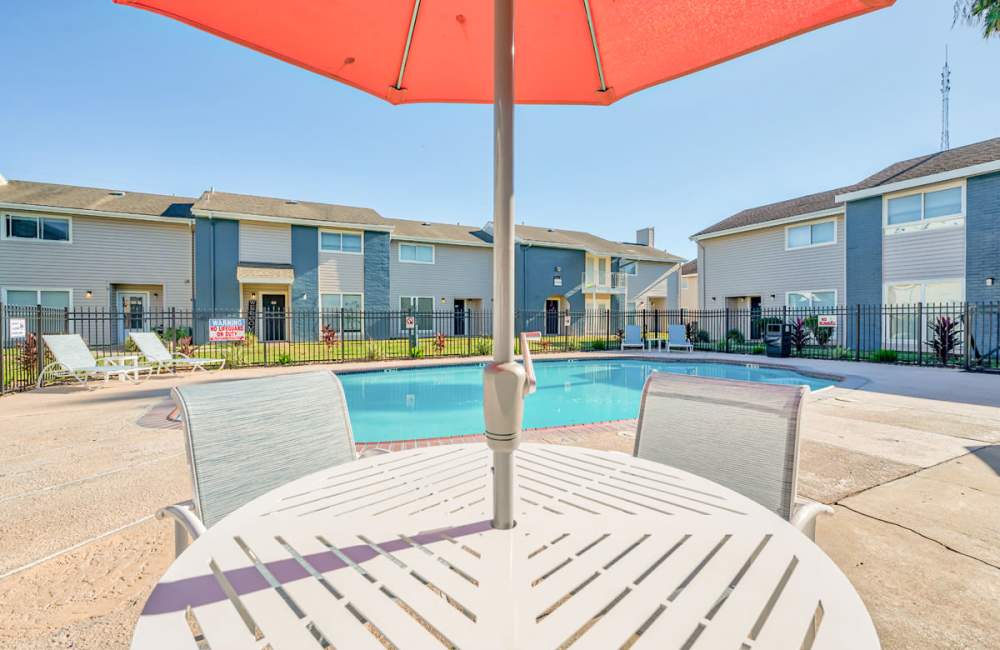 Community swimming pool with a sitting area on the deck at South Shore Coastal Living in Corpus Christi,Texas