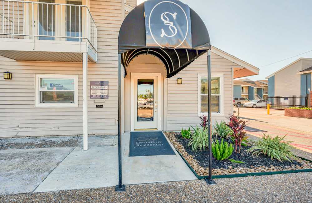 Property entrance with a property logo on the sun shade at South Shore Coastal Living in Corpus Christi,Texas