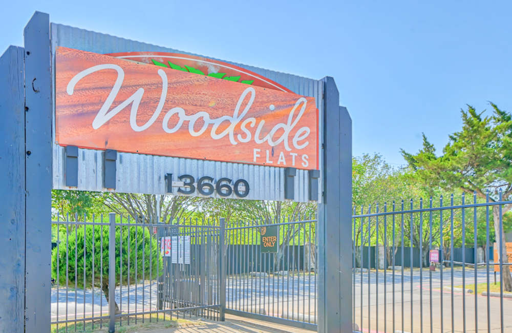 Property entrance with a sign board around Woodside Flats in Dallas, Texas, 