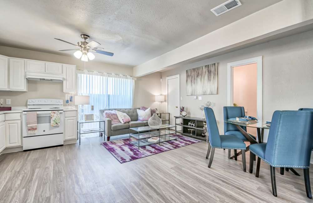 Living room with seating and hard-wood style flooring at Woodside Flats in Dallas, Texas, 