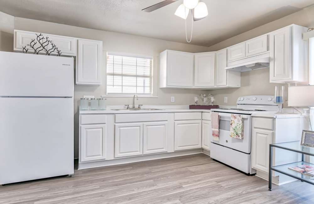 Kitchen with storage and white appliances at Woodside Flats in Dallas, Texas, 