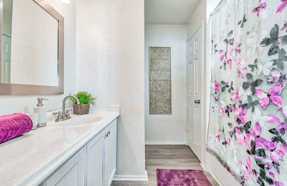 Well-lit bathroom at Woodside Flats in Dallas, Texas, 