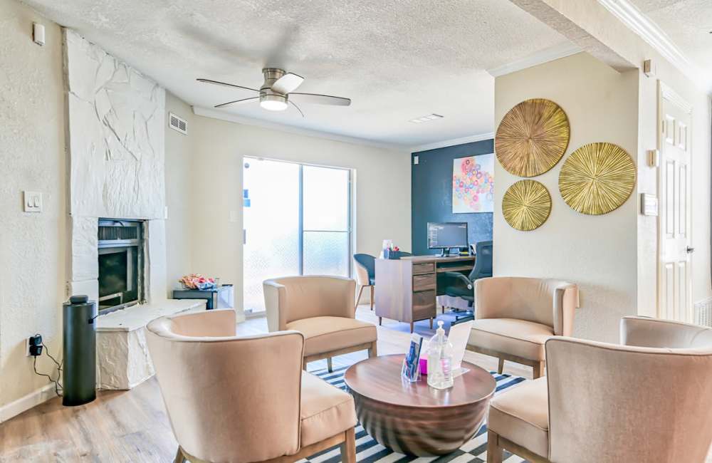 Spacious living room with ceiling fan and hard-wood style flooring at Woodside Flats in Dallas, Texas, 
