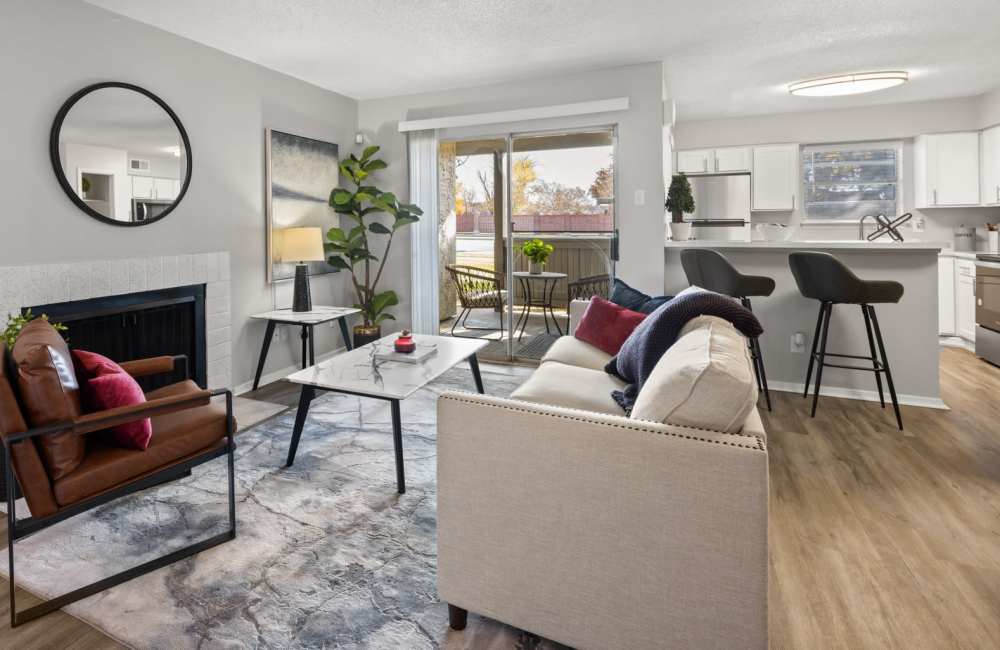 Spacious living room with wood-style flooring and cream accent throughout at 18Eleven Frankford in Carrollton,Texas