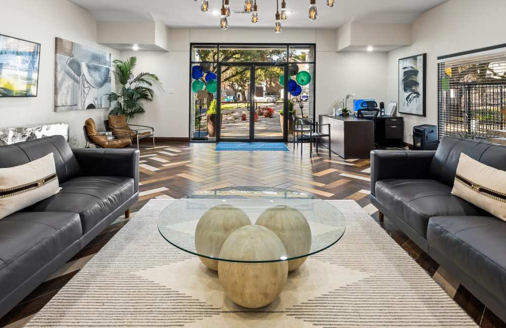 Clubhouse with large seating and hard-wood style flooring at Lavera At Lake Highlands in Dallas, Texas 