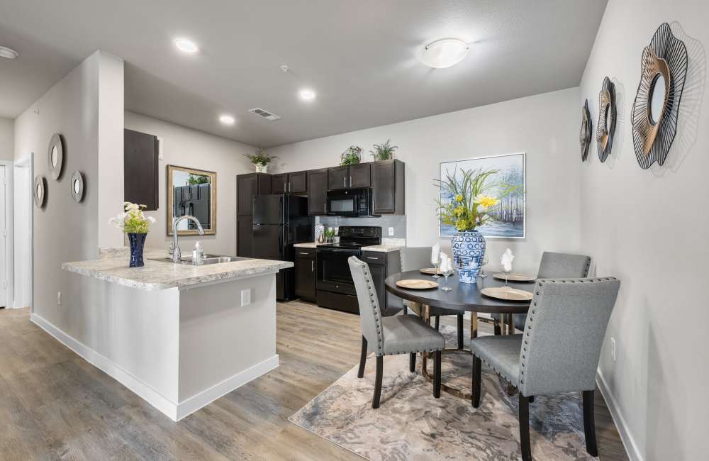 Kitchen with wood-style flooring at The Tennyson at Tomball in Tomball, Texas
