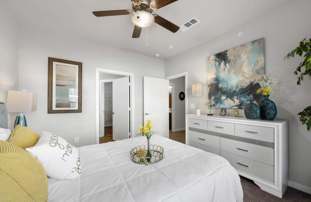 Bedroom with a ceiling fan at The Tennyson at Tomball in Tomball, Texas