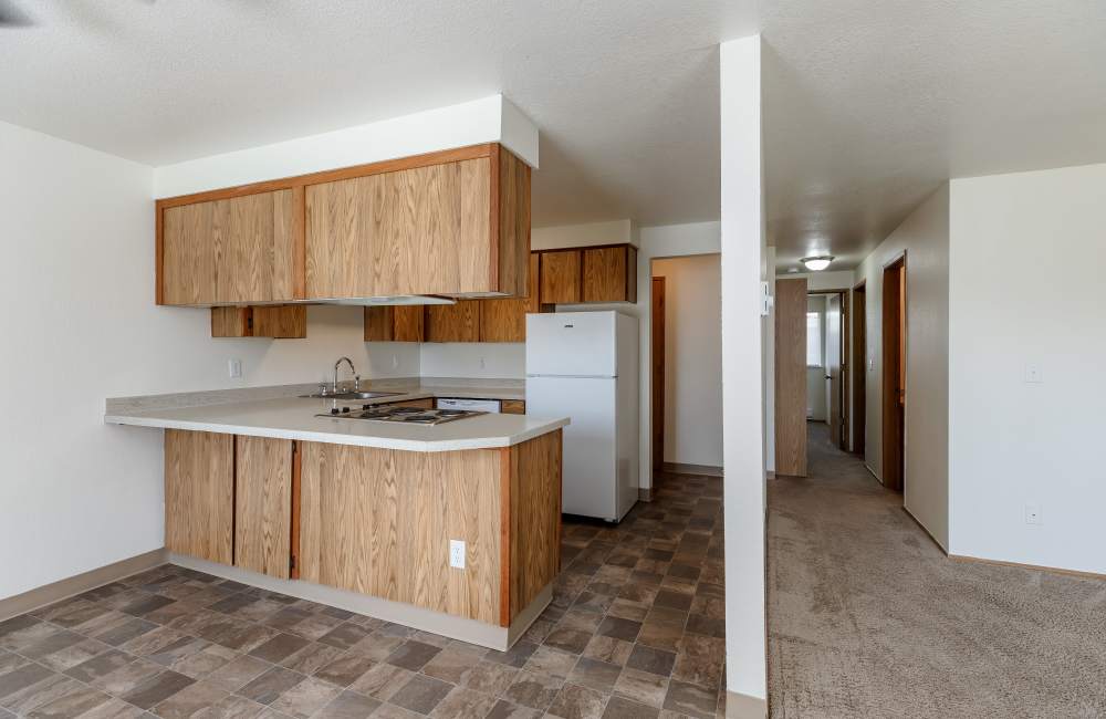 Kitchen and entryway at Heron Hills Apartment Homes in Gresham, Oregon
