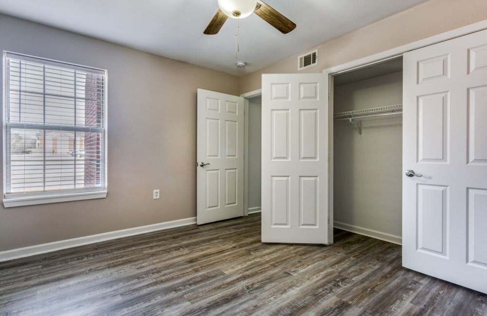 Bedroom with closet and ceiling fan at Boomer Creek Apartments in Stillwater, Oklahoma